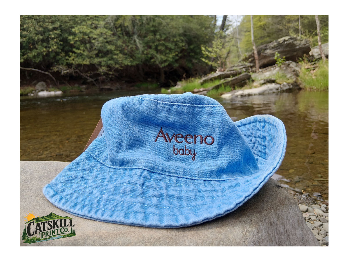 Embroidered blue bucket hat photographed by a creek in the Hudson Valley