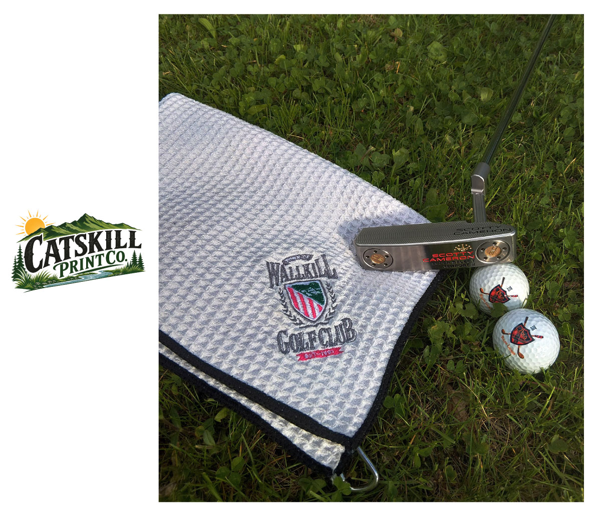 Embroidered golf towel photographed on grass